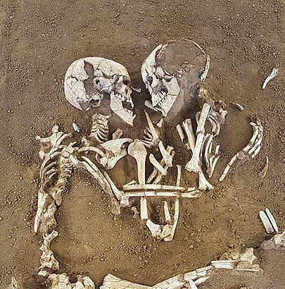 A pair of skeletons appear to embrace
